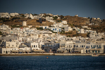 View of whitewashed houses on a hill of Aegean island of Mykonos, Greece, on a sunny summer day.