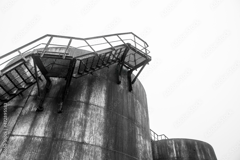 Wall mural Fuel old chemical tank barrel oil in an industrial abandoned plant