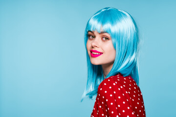 joyful woman in purple wig glamor posing blue background