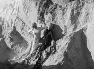 Two girls in a white and black bodysuit on the sand in the image of good and evil.