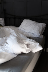 Fototapeta na wymiar Soft pillows and duvet on comfortable bed