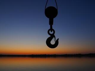Harbor hook or bracket for transporting goods in a port or pier. The hook is a clue against the...