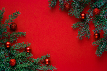 Christmas red background with fir branches, a place to copy