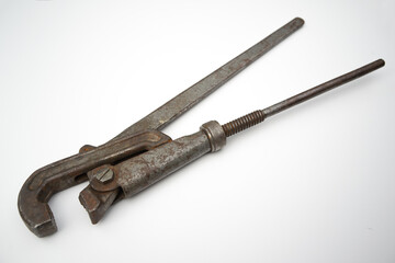 A large metal gas wrench on a white isolate. An old rusty tool on a white background.