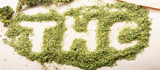 THC lettering on green shredded marijuana buds medical cannabis