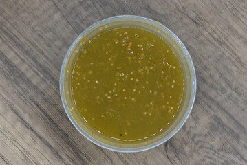 Overhead view of large container of fresh homemade red salsa ready to serve as a dip