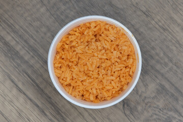 Overhead view of generous portion of Mexcian rice in a small container to eat as a side dish with...