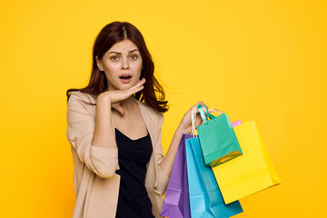Fototapeta na wymiar smiling woman with multicolored bags posing isolated background