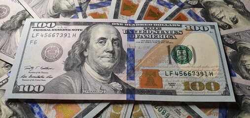 One hundred dollars on the table. American currency. Dollar exchange rate. Much money. Dollars...