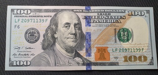 One hundred dollars on the table. American currency. Dollar exchange rate. Much money. Dollars background.