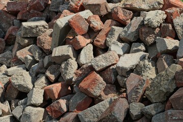 stone texture made of debris from pieces of gray red bricks