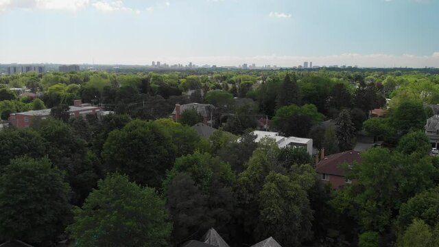 A shot rises up from a rooftop to reveal a distant city skyline.