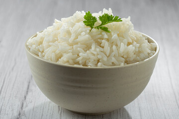 Bowl with cooked rice on the table.
