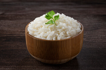 Bowl with cooked rice on the table.