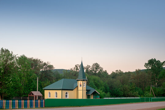 A small mosque located far away in the village.