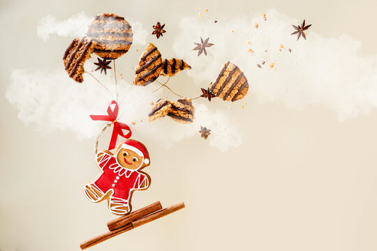 Christmas cookies, Santa cookie flying on cookies balloons into clouds, creative xmas bakery photo, levitation food trend photo. 