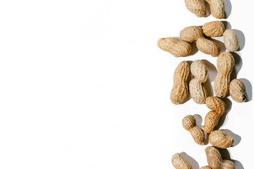 Fototapeta na wymiar Various peanuts with shell on white background. copy space