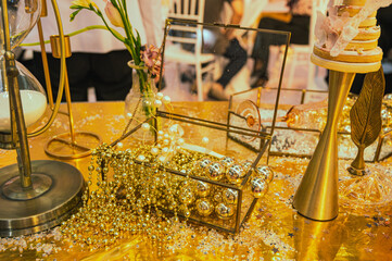 an open box of glittering golden balls and small crystals resembling diamonds on a wedding exhibition in shenzhen, china