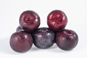 A bunch of plums on a white background.