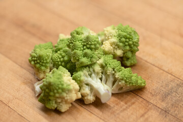 Romanesco cauliflower broccoli florets on a wooden chopping board