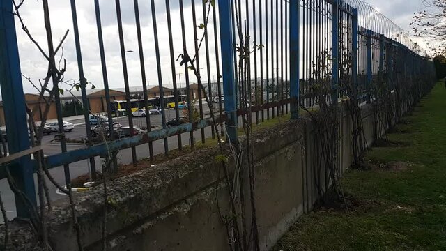 Security fences installed along the roadside form a protective barrier, emphasizing safety, infrastructure, and controlled boundaries within an outdoor urban or highway environment.