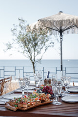 set table on the terrace against the backdrop of the sea or ocean