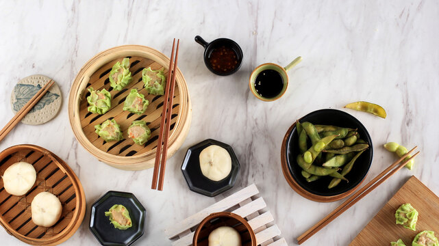 Various Flat Lay Chinese Food, Dim Sum on Bamboo Steamer Above Marble Top