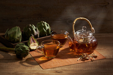artichoke teapot with wooden tray in wooden background for product advertising , front view , food...