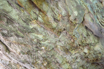 Abstract background. Stone formation of a sheer cliff close-up.