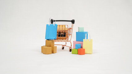 miniature trolley filled with colorful boxes and mini bags isolated on white background - Powered by Adobe
