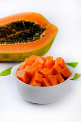 Papaya orange fresh on white dish and papaya slice. Space for text