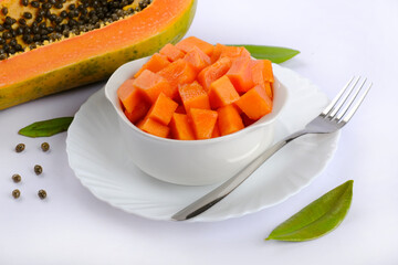 Papaya orange fresh on white dish and papaya slice. Space for text