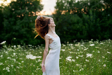 Obraz premium Woman in white dress in a field flowers sun nature freedom