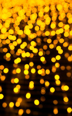 Gold bokeh abstract with neon light bright night and dark black background. defocused poster card...