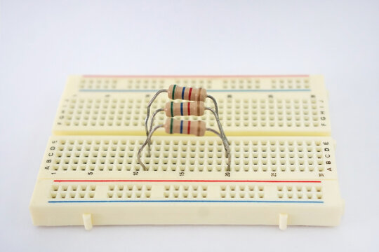 Fixed resistors connected in Parallel electrical circuit on a protoboard, on white background. Laboratory instruments in physics and engineering. Science education.
