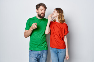 married couple multicolored t-shirts communication quarrel light background