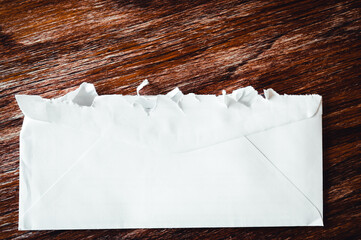 Selective focus on jagged edges of a ripped open mail envelope 