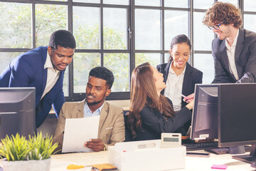 Colleagues in a boardroom discussion, seated at a table together, swapping ideas and strategizing...