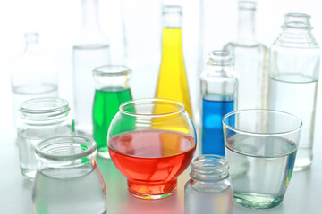 色の付いた水が入った瓶やコップ