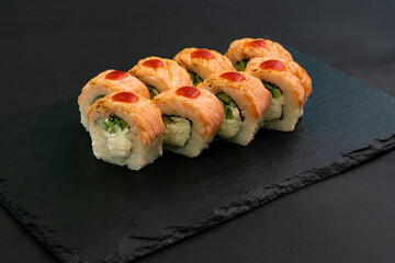 Grilled Philadelphia roll sushi with salmon, prawn, avocado, cream cheese. Sushi menu. Japanese food.