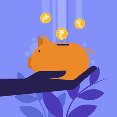 Hand holding piggy bank with Indian Rupee coins falling in to it