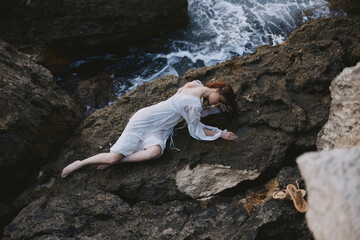 Barefoot woman in white wedding dress on sea shore wet hair nature