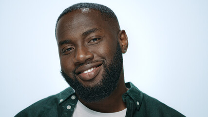 Portrait of playful african american man flirting on camera in studio.