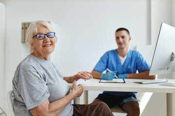 Fototapeta premium elderly woman patient sitting in the doctor's office visit to the hospital