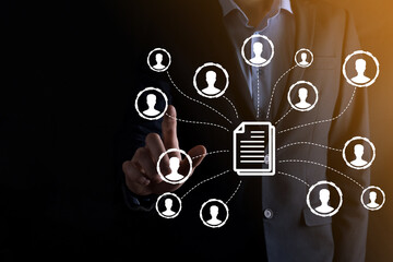Fototapeta premium Man hold document and user icon.Corporate data management system DMS and document management system concept. Businessman click or publish on document connected with corporate users