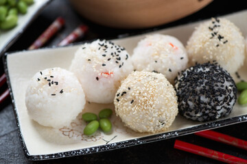 Close-up of japanese onigiri or rice with various stuffing formed into ball shapes, selective focus
