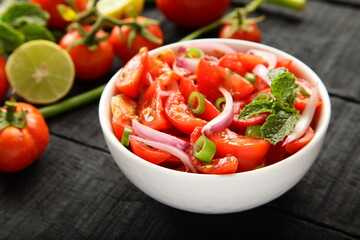Bowl of healthy and delicious organic tomato , onions salad. 