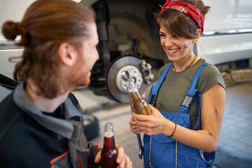 Girl mechanic on a break with male colleague