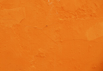 Abstract background of orange plaster on an old wall.