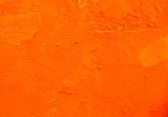Abstract background of orange plaster on an old wall.